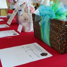 Gift baskets and bid sheets on the silent auction table