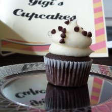 A chocolate cupcake with white cream, topped with chocolate chips, from Gigi's Cupcakes