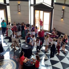 Aerial view of guest gathered near ticket and takeout box tables in the Shelby Hall Rotunda