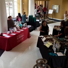 View of the silent auction table and a body image table featuring cupcakes from Angel Cakes